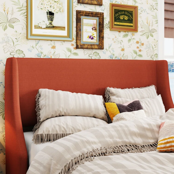 Burnt orange upholstered queen platform bed with wingback headboard, tapered legs, and slatted base – no box spring required