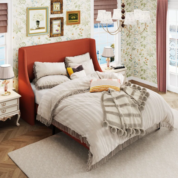 Burnt orange upholstered queen platform bed with wingback headboard, tapered legs, and slatted base – no box spring required