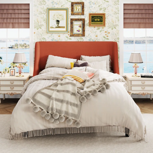 Burnt orange upholstered queen platform bed with wingback headboard, tapered legs, and slatted base – no box spring required