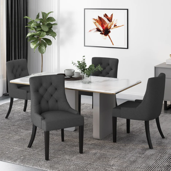 Set of four dark charcoal grey upholstered dining chairs featuring diamond tufted backs, armless design, sloped sides, and espresso wood legs.