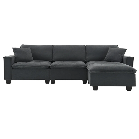 Charcoal grey suede L-shaped sectional sofa with tufted cushions, reversible chaise, removable ottoman, and two matching throw pillows