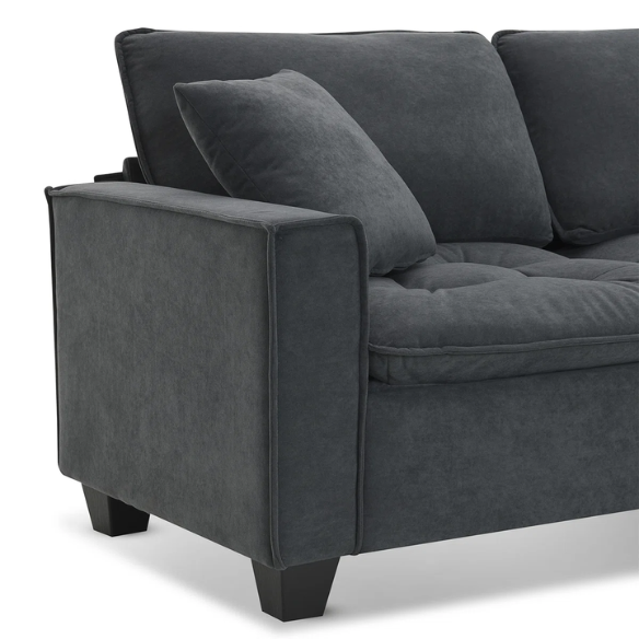 Charcoal grey suede L-shaped sectional sofa with tufted cushions, reversible chaise, removable ottoman, and two matching throw pillows