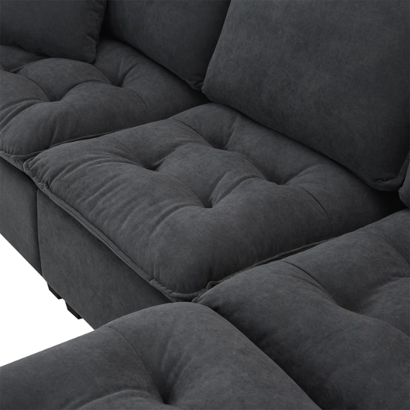 Charcoal grey suede L-shaped sectional sofa with tufted cushions, reversible chaise, removable ottoman, and two matching throw pillows