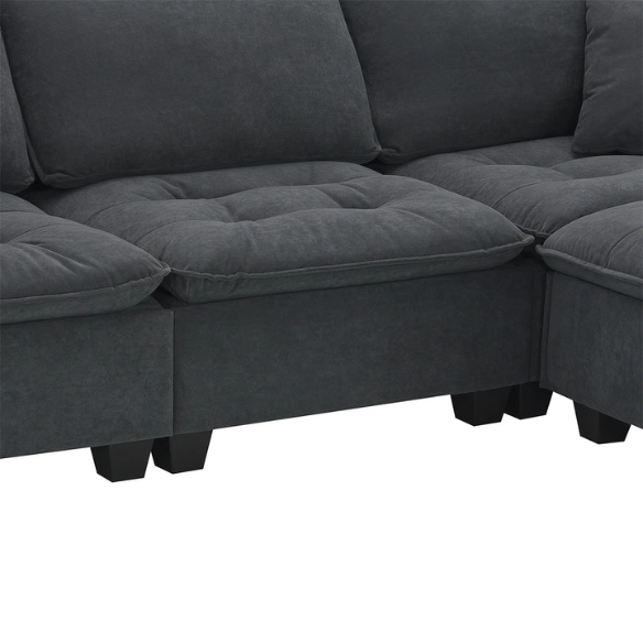 Charcoal grey suede L-shaped sectional sofa with tufted cushions, reversible chaise, removable ottoman, and two matching throw pillows