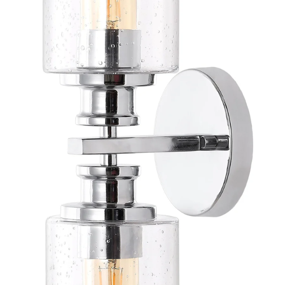 Polished chrome wall sconce with dual clear seeded glass cylinder shades and Edison-style LED bulbs, ideal for modern bathrooms or entryways