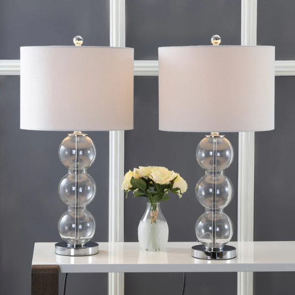 Set of 2 clear glass table lamps with triple-sphere design, polished silver accents, and white linen drum shades – elegant lighting for bedroom, living room, or office
