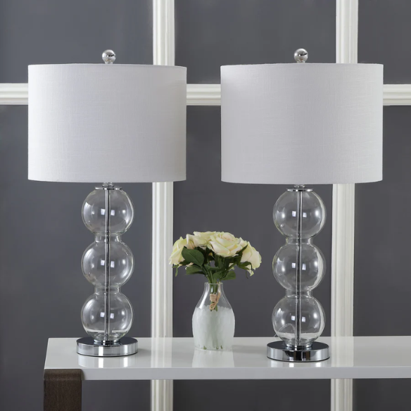 Set of 2 clear glass table lamps with triple-sphere design, polished silver accents, and white linen drum shades – elegant lighting for bedroom, living room, or office