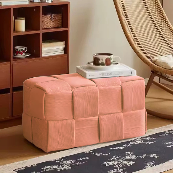 Blush velvet ottoman with modern cube design and durable wood frame.