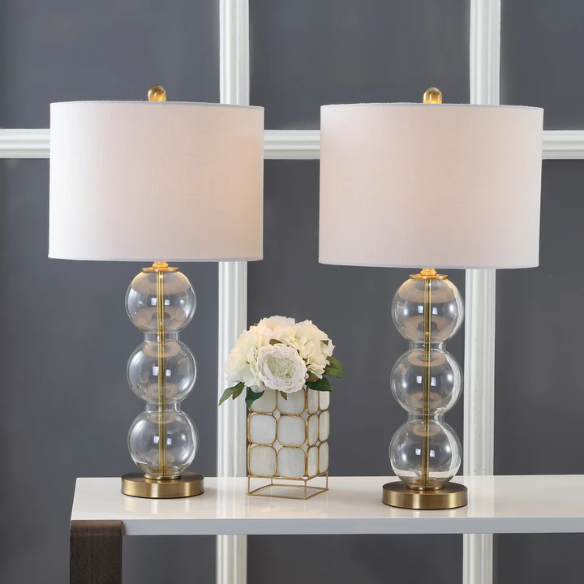 Set of 2 contemporary table lamps with clear glass triple-sphere base, gold accents, and white linen drum shade – modern glam bedside or living room lighting