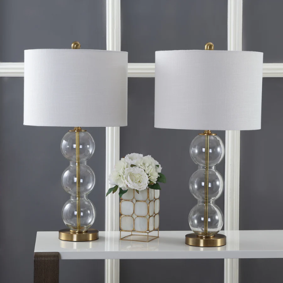 Set of 2 contemporary table lamps with clear glass triple-sphere base, gold accents, and white linen drum shade – modern glam bedside or living room lighting