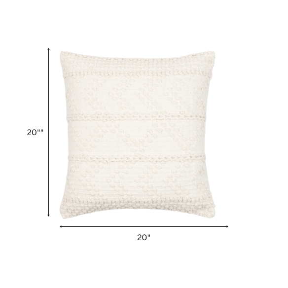 Cream handwoven boho throw pillow with chevron texture on a modern neutral-toned sofa