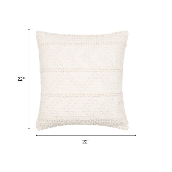 Cream handwoven boho throw pillow with chevron texture on a modern neutral-toned sofa