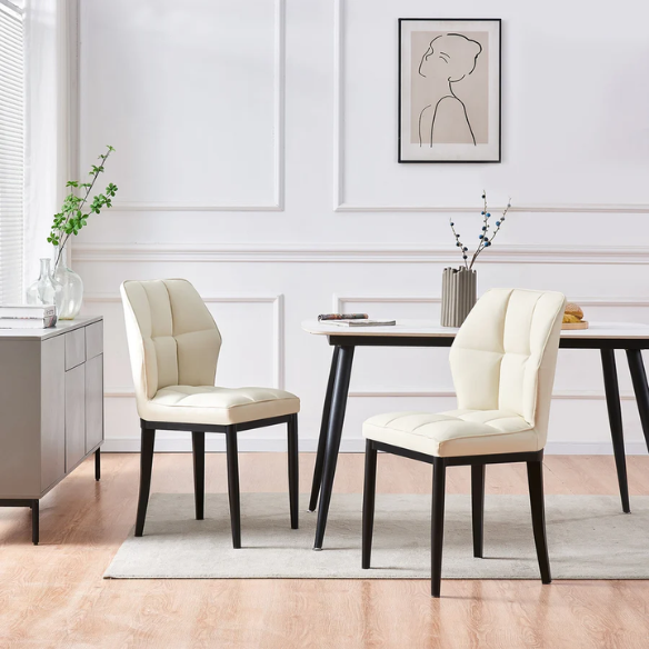 Set of two cream mid-century modern faux leather dining chairs with checkered stitching and metal legs