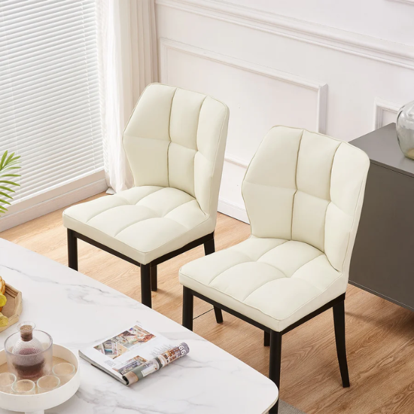 Set of two cream mid-century modern faux leather dining chairs with checkered stitching and metal legs