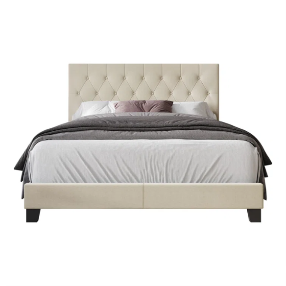 Cream linen full size upholstered bed with button tufted headboard and low-profile legs