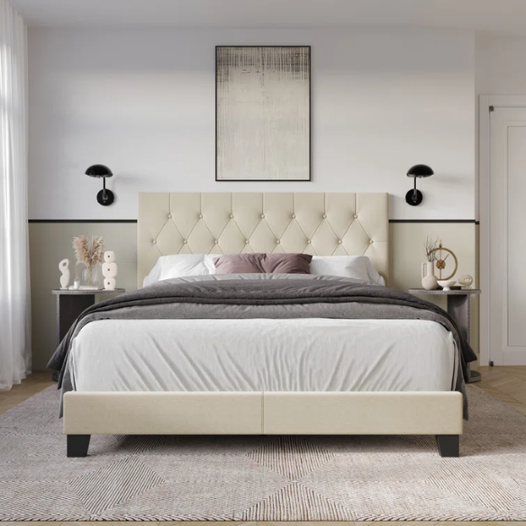 Cream linen full size upholstered bed with button tufted headboard and low-profile legs