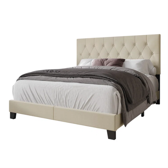 Cream linen full size upholstered bed with button tufted headboard and low-profile legs