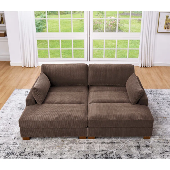 Dark brown corduroy convertible sleeper sofa with adjustable headrest, twin bed functionality, and mid-century wooden legs