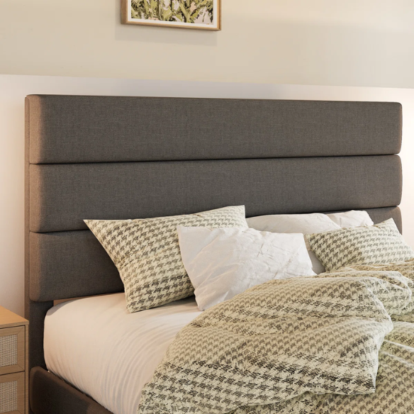 Dark grey king-size upholstered platform bed with padded headboard, slat support system, and no box spring needed