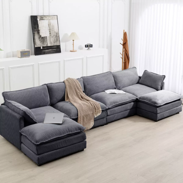 Dark grey 4-seat modular sectional sofa with two matching ottomans, upholstered in soft corduroy with high-resilience cushions and a sturdy wood and metal frame.