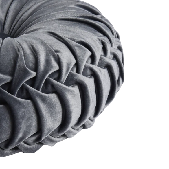 Dark grey velvet round throw pillows with hand-pleated design and button center, set of two 14.5-inch plush cushions styled in a modern living space.