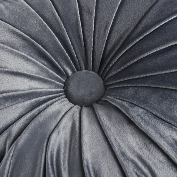 Dark grey velvet round throw pillows with hand-pleated design and button center, set of two 14.5-inch plush cushions styled in a modern living space.