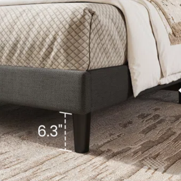 Dark grey upholstered queen platform bed with wingback headboard, slatted base, and black tapered legs – no box spring required