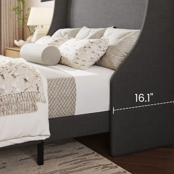 Dark grey upholstered queen platform bed with wingback headboard, slatted base, and black tapered legs – no box spring required
