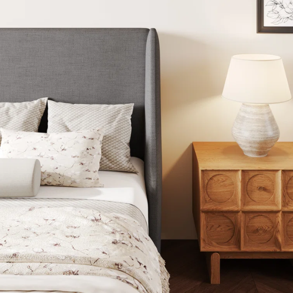Dark grey upholstered queen platform bed with wingback headboard, slatted base, and black tapered legs – no box spring required
