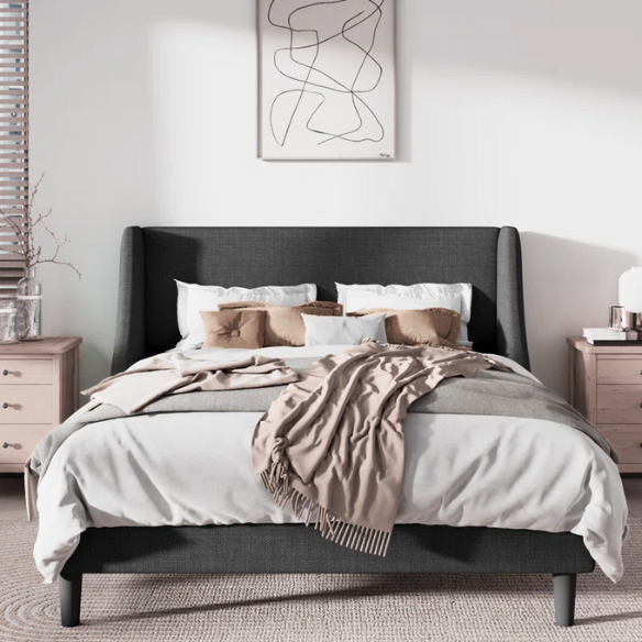 Dark grey upholstered queen platform bed with wingback headboard, slatted base, and black tapered legs – no box spring required