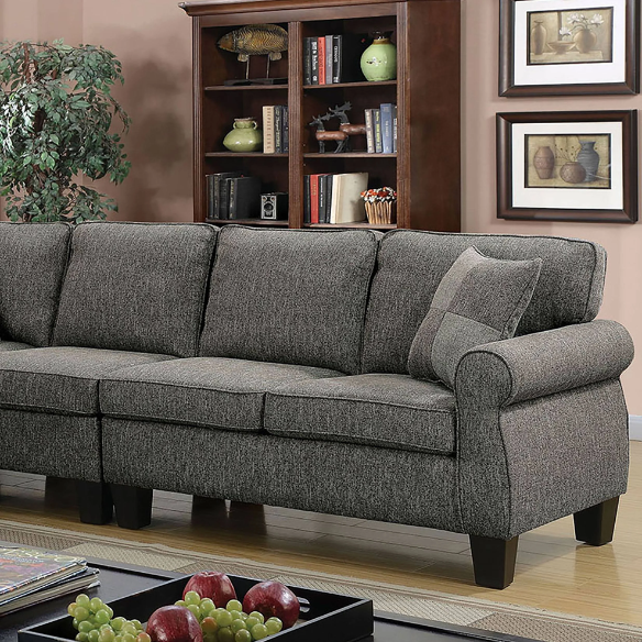 Dark grey transitional L-shaped sectional sofa with rolled arms, welt-trimmed cushions, and checkerboard accent pillows