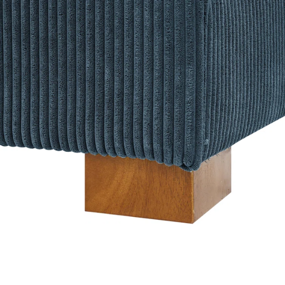 Deep blue corduroy convertible sleeper sofa with adjustable headrest, twin bed functionality, and mid-century wood legs