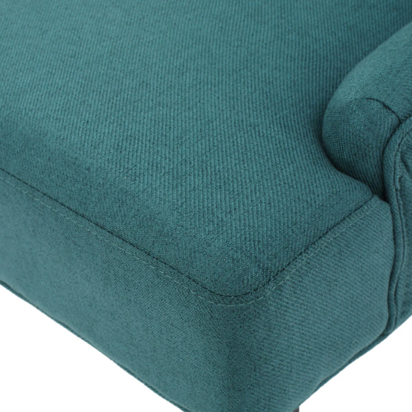 Set of four deep teal upholstered dining chairs with diamond tufted backs, armless design, sloped sides, and espresso brown wooden legs.