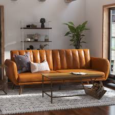 Stylish faux leather futon with ribbed tufted back, oak-colored wooden legs, and multi-position split-back for sitting, lounging, and sleeping. Ideal for small spaces, offering comfort and versatility with a sturdy frame, easy conversion, and extra support for guests.