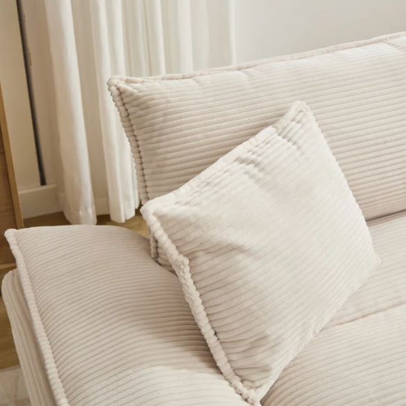 84-inch beige corduroy loveseat with striped upholstery, pillow-top arms, and two accent pillows—modern, low-profile design for living rooms or small spaces.