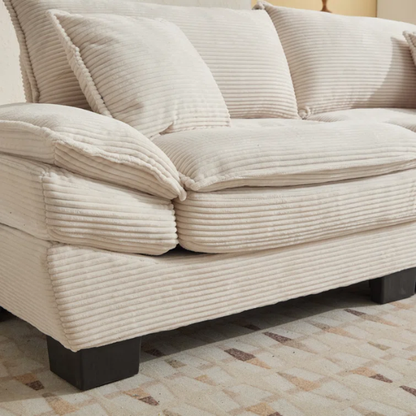 84-inch beige corduroy loveseat with striped upholstery, pillow-top arms, and two accent pillows—modern, low-profile design for living rooms or small spaces.