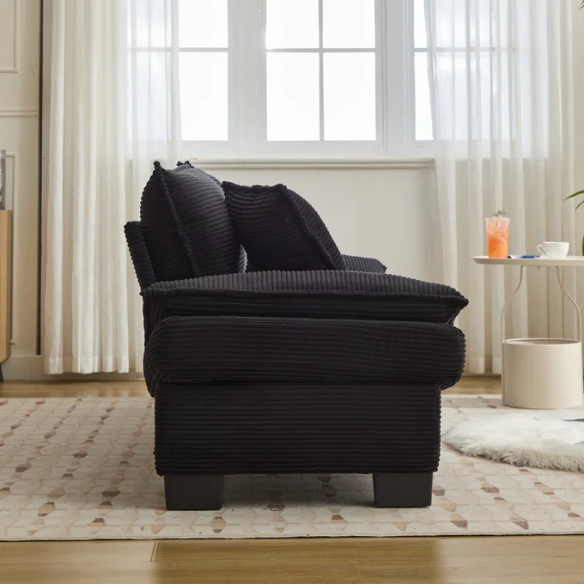 84-inch black corduroy loveseat with striped upholstery, pillow-top arms, and two accent pillows—modern, low-profile design ideal for contemporary living rooms or compact spaces.