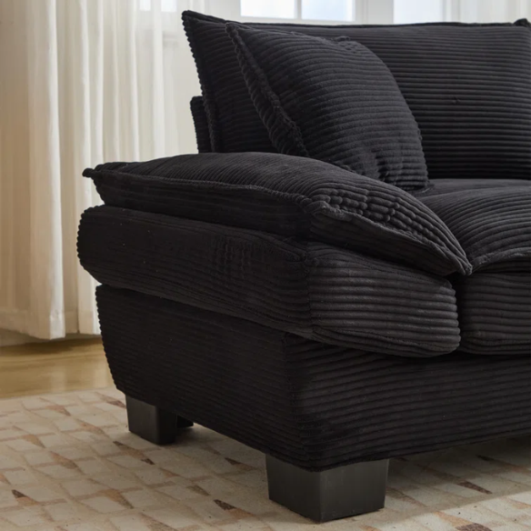 84-inch black corduroy loveseat with striped upholstery, pillow-top arms, and two accent pillows—modern, low-profile design ideal for contemporary living rooms or compact spaces.