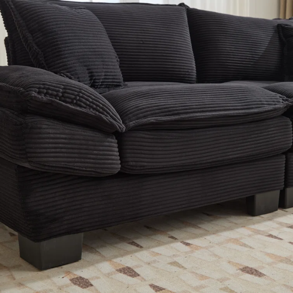 84-inch black corduroy loveseat with striped upholstery, pillow-top arms, and two accent pillows—modern, low-profile design ideal for contemporary living rooms or compact spaces.