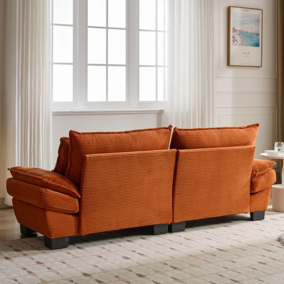 84-inch burnt orange corduroy loveseat with striped upholstery, pillow-top arms, and two accent pillows—modern, low-profile design ideal for vibrant, stylish interiors.