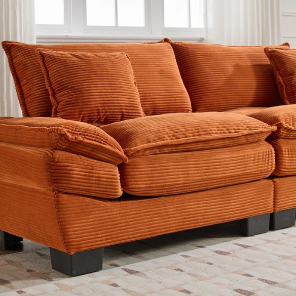 84-inch burnt orange corduroy loveseat with striped upholstery, pillow-top arms, and two accent pillows—modern, low-profile design ideal for vibrant, stylish interiors.