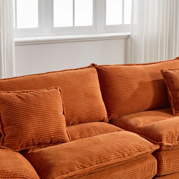 84-inch burnt orange corduroy loveseat with striped upholstery, pillow-top arms, and two accent pillows—modern, low-profile design ideal for vibrant, stylish interiors.