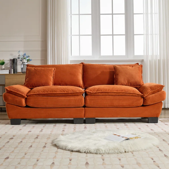 84-inch burnt orange corduroy loveseat with striped upholstery, pillow-top arms, and two accent pillows—modern, low-profile design ideal for vibrant, stylish interiors.