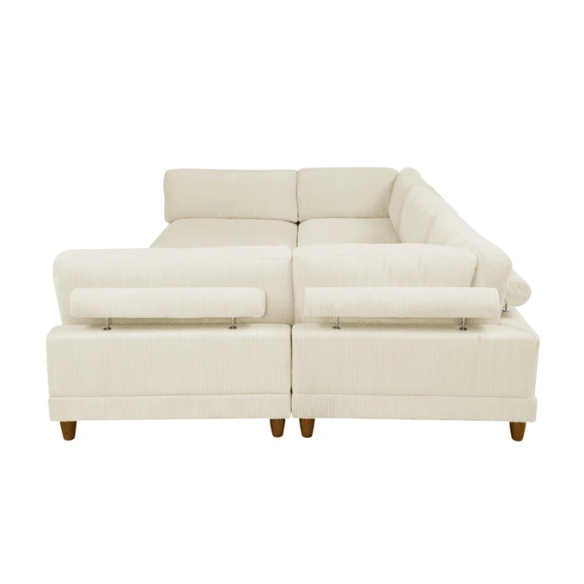 Beige modular sectional sofa with corduroy upholstery, removable cushions, and matching ottoman – seats six in a modern L-shaped or U-shaped layout with solid wood legs.