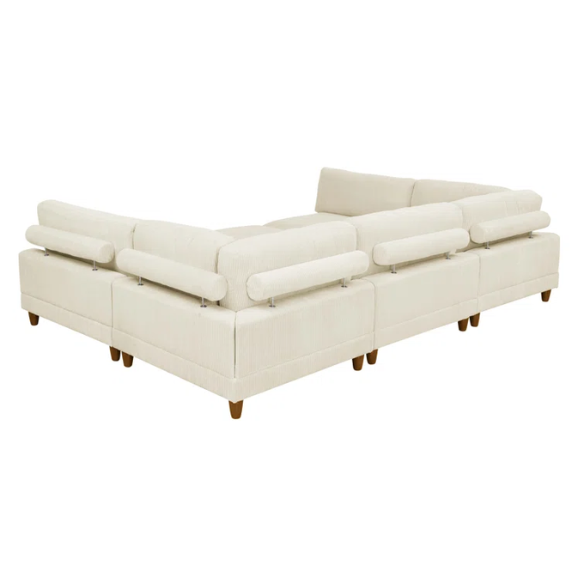 Beige modular sectional sofa with corduroy upholstery, removable cushions, and matching ottoman – seats six in a modern L-shaped or U-shaped layout with solid wood legs.