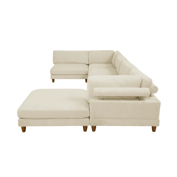 Beige modular sectional sofa with corduroy upholstery, removable cushions, and matching ottoman – seats six in a modern L-shaped or U-shaped layout with solid wood legs.