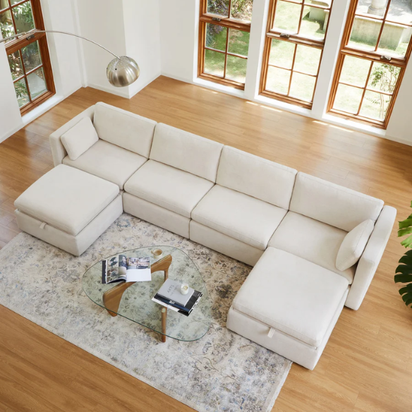 Beige six-piece modular sofa set featuring wide chenille-upholstered seats, two storage ottomans with gas-lift lids, and reversible cushions — ideal for contemporary, mid-century, or transitional interiors.