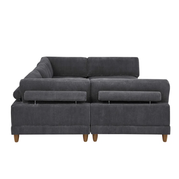 Dark grey modular sectional sofa with soft corduroy upholstery, matching ottoman, and removable cushions — seats six with flexible L- or U-shaped configurations.