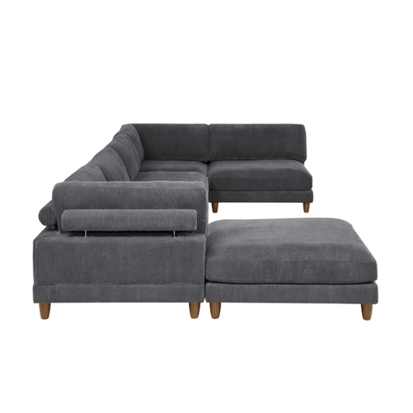 Dark grey modular sectional sofa with soft corduroy upholstery, matching ottoman, and removable cushions — seats six with flexible L- or U-shaped configurations.
