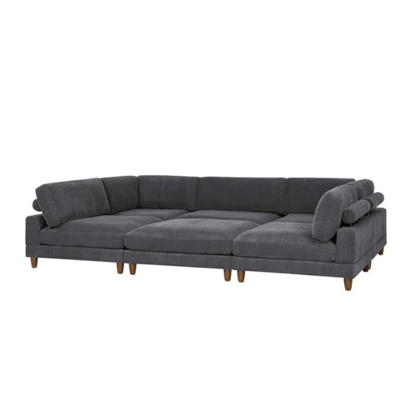 Dark grey modular sectional sofa with soft corduroy upholstery, matching ottoman, and removable cushions — seats six with flexible L- or U-shaped configurations.